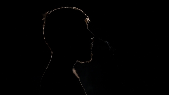 Man Smoking Electronic Cigarette Breathing Out Smoke. Black. Silhouette alt