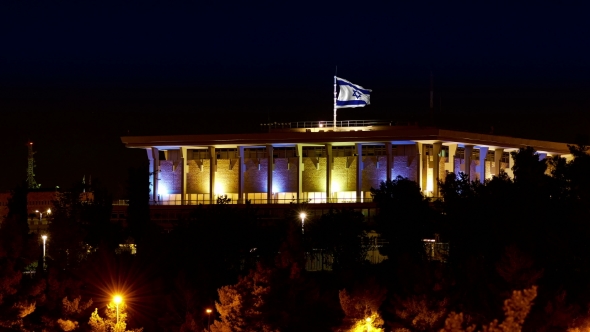Knesset With Flying Waving Flag Of Israel At Night