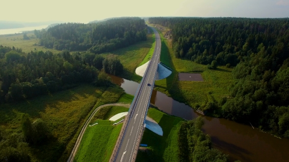 Aerial View Of Cars Going Over The Bridge In The Forest