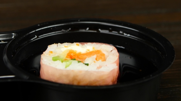 Person Prepares The Roll For Eating alt