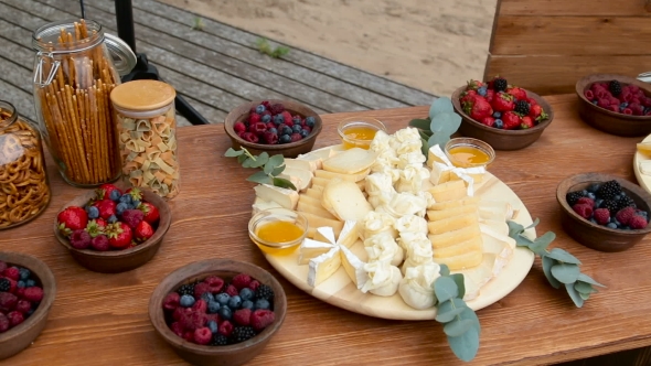 Festive Wooden Table On The Street With Different Food In Welkom alt