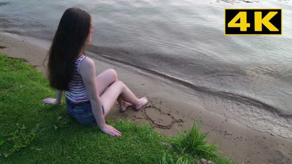 Yung Girl Draws a Heart On Sand