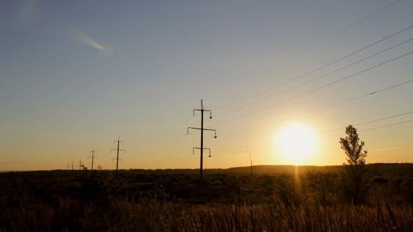  High Voltage Electricity Power Lines At Sunset Above The Beautiful