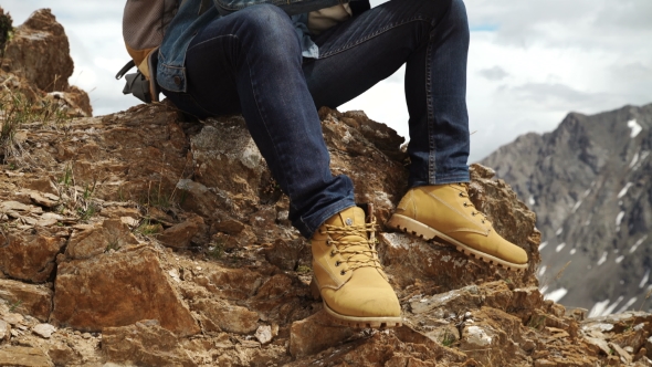 Man's Hands Touching Screen of Digital Tablet on the Background of Mountains alt