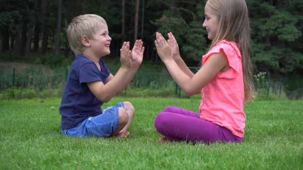 Children Playing On The Grass