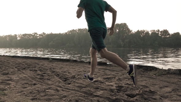 Super  Steadicam Video Of Athletic Man Running On Sandy Riverside, 240 Fps alt