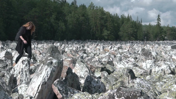 Girl Does Yoga On The Rocks