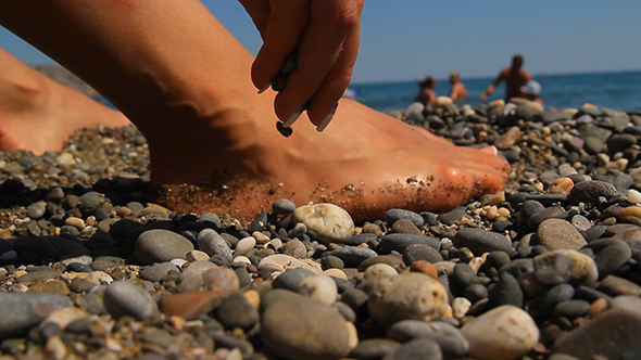 Feet on a rocky seashore