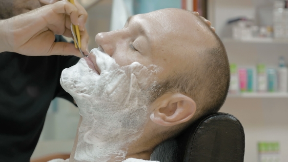 Barber Is Shaving His Client In Old Fashion Manner