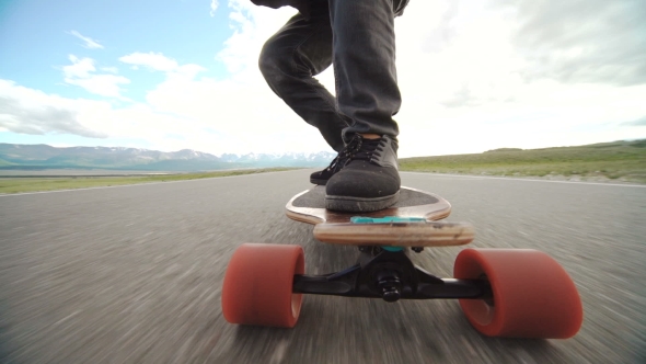 Guy On His Longboard Skate.  Of Longboard And Foot. Side View. Tracking Shot