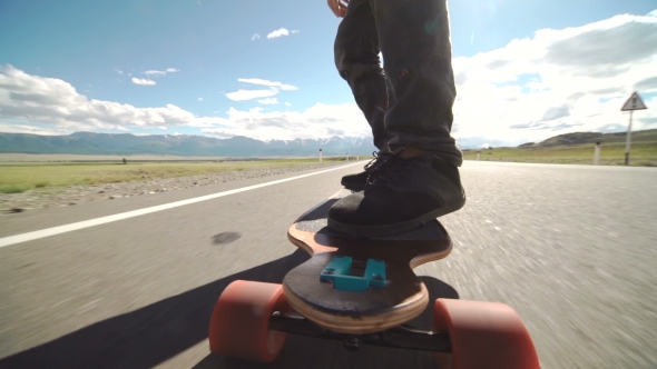 Guy On His Longboard Skate.  Of Longboard And Foot. Side View. Tracking Shot alt