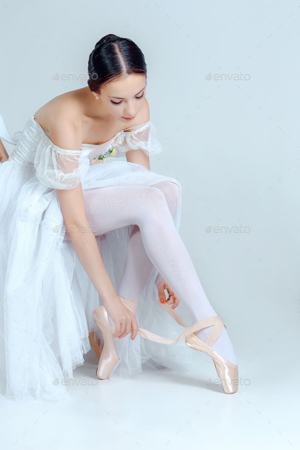Professional ballerina putting on her shoes Stock Photo by master1305