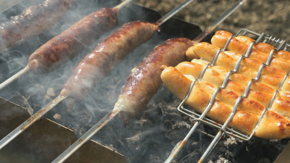 Sausages Grilling Over The Hot Glowing Coals