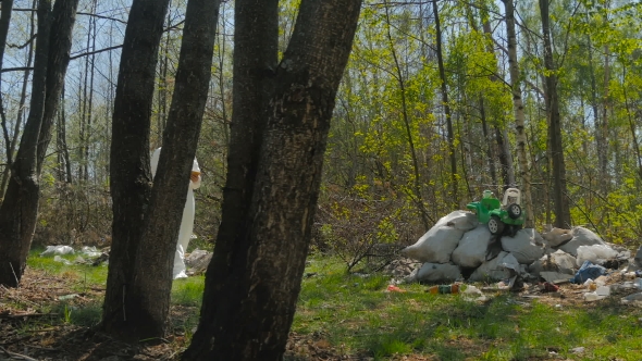 Man In Mask Walking With Tablet Near The Midden alt