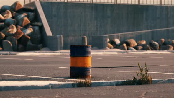 Old and Rusty Metal Barrel on Parking alt