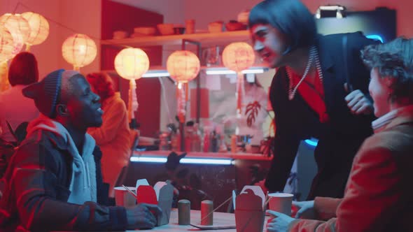 Transgender Man Meeting with Multiethnic Friends in Chinese Restaurant alt
