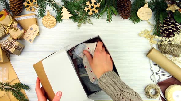 Woman hands packing gift alt