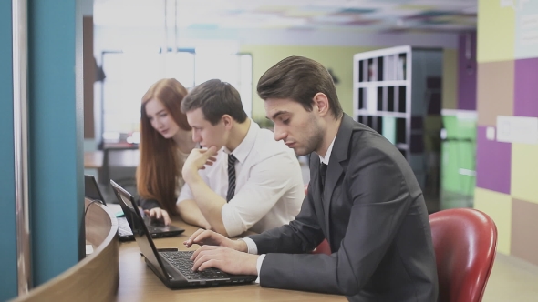 Man Working On Laptop In Office alt