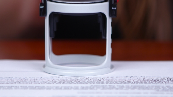 People Puts The Round Stamp On The Document.  alt