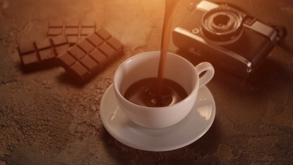 White Cup With Chocolate Bar And Retro Camera