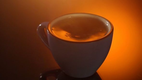 Cup Of Hot Tea With Steam On Shiny Background.