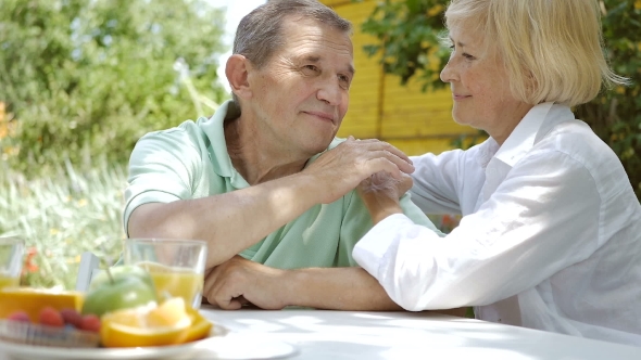 Man And Woman Sitting In The Garden And Smile., Stock Footage 