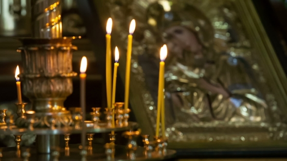 Russian Church Candles And Icon Behind