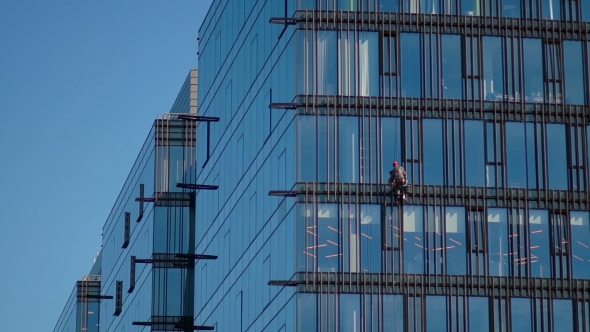 Industrial Mountaineering Workers Wash Windows Of a High-rise Building
