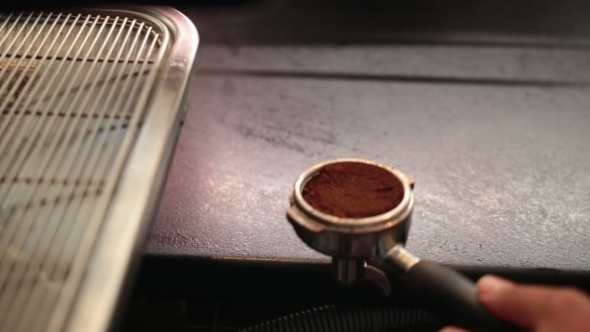 Barista Using a Tamper To Press Ground Coffee alt
