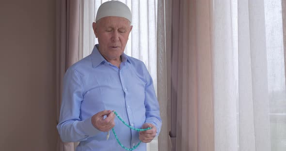 An Old Man with Rosary Beads Praying