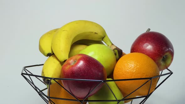 Rotating Fruit Basket with Fresh Bananas Apple Orange and Grapefruit for a Healthy Lifestyle