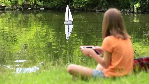 Girl With Remote Controlled Boat