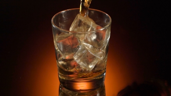 Single Glass Of Whisky Bourbon On Ice On Shiny Background