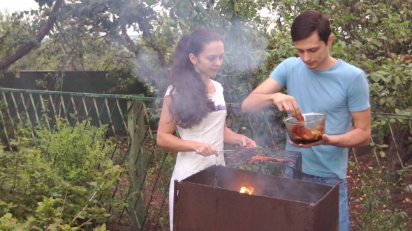 Couple Near The Barbecue.