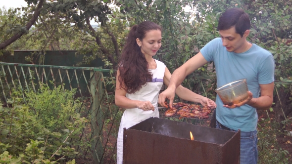 Couple Near The Barbecue.