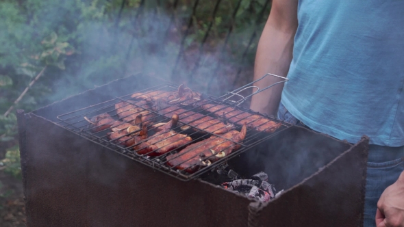 Man Prepares Food On The Grill