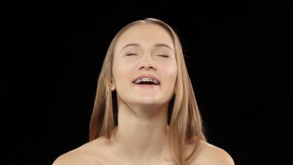 Woman Laughs And Shows Her Smile With Braces. Black alt