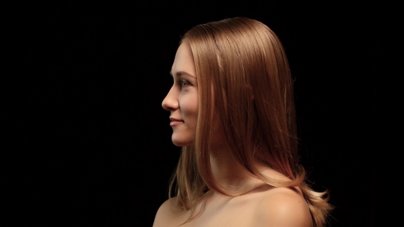 Woman With Braces And a Beautiful Hair Color Turns To The Camera And Winking With One Eye. Black alt