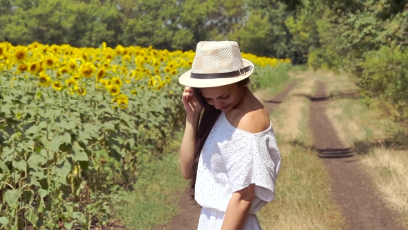 Woman Runs Across The Road Near a Field Of Sunflowers