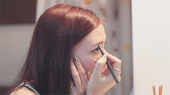 Woman Does Makeup on Eyebrows