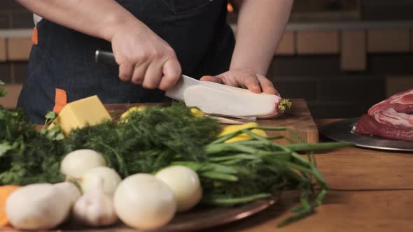 Chef Cuts Daikon Radish Slices on Cutting Board alt