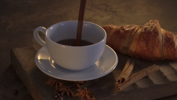 Hot Chocolate With Croissants And Cinnamon Sticks On Grunge Table