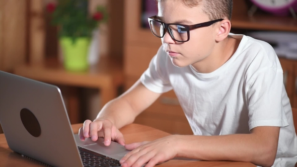 Teen Boy Working On Laptop