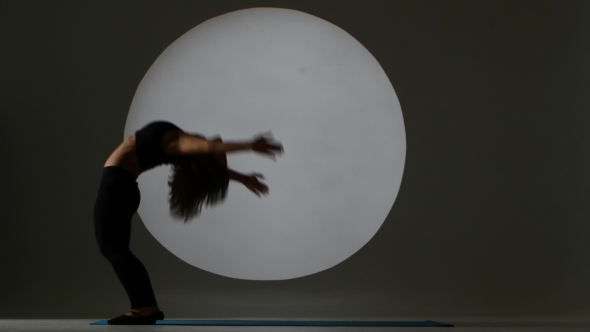 Gymnast Stands With The Posture Of The Bridge. Back Light alt