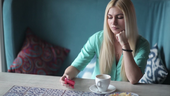 Young Woman Checks a Notification On Your Phone. alt