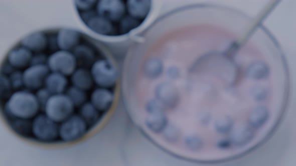Bowl with Yogurt and Blueberries on Table alt