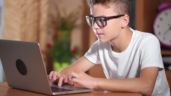 Teen Boy Working On Laptop