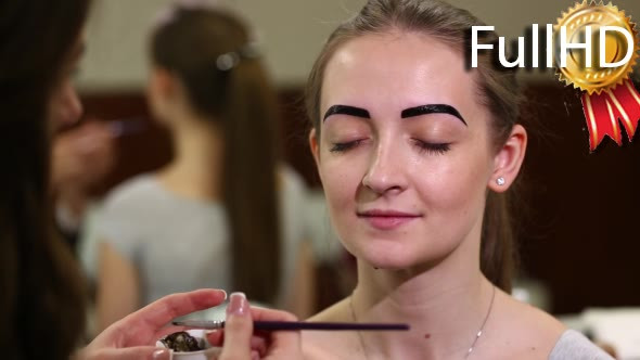 Beautician Colors the Eyebrows With Henna