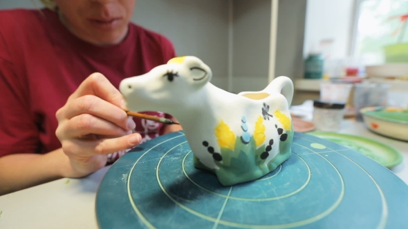 Artist Paints a Clay Figure alt