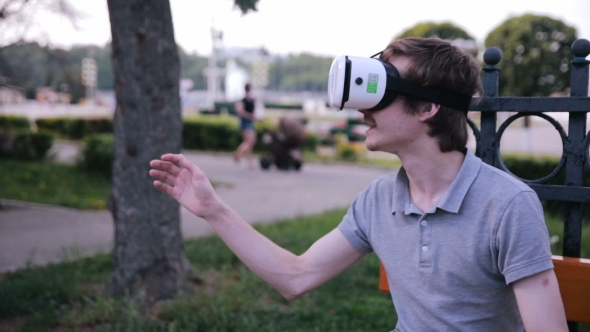 Young Man In 360 VR Glasses. Virtual Reality Glasses. alt